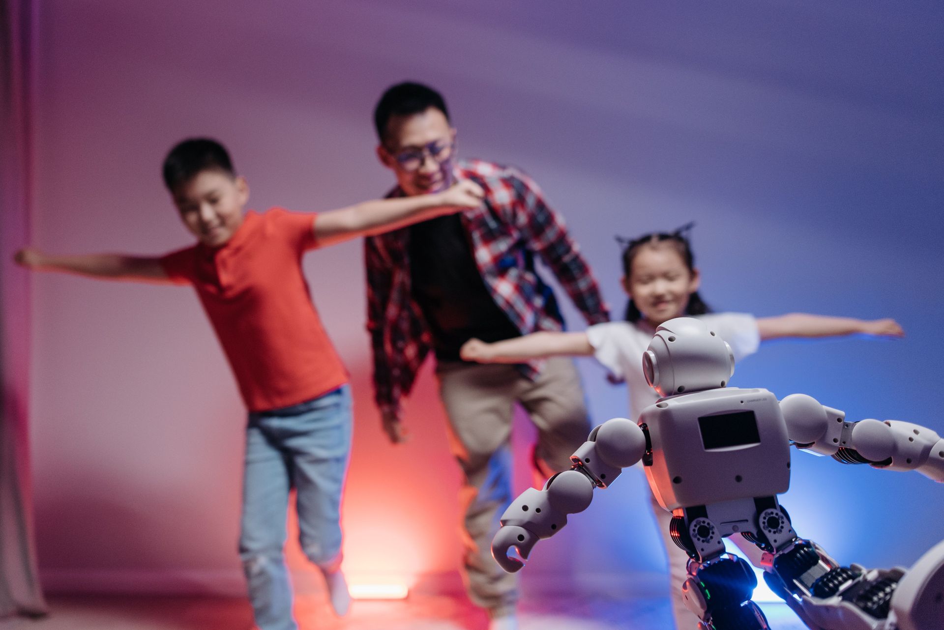 Father and daughter playing with a home robot